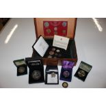 A wooden box and contents of various cased coins i