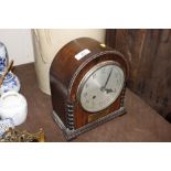 An oak cased mantel clock, presented to Captain an