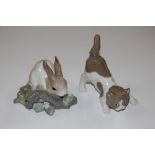 A Lladro porcelain figure of a cat; and another of