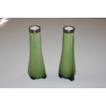 A pair of green opaque glass spill vases with silv