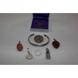 A silver torque bangle, pendants and filigree shie