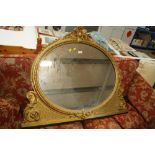 An ornate gilt framed over-mantel mirror