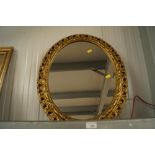 An oval gilt framed wall mirror