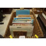A box of postcards and cigarette card albums