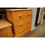 A stripped pine chest fitted three drawers