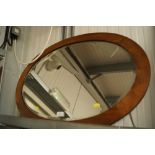 An oval framed and bevelled edge wall mirror