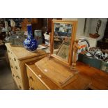 A pine dressing table mirror with storage compartm