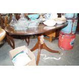 A reproduction mahogany oval dining table