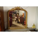 A ornate gilt framed oval mantel mirror