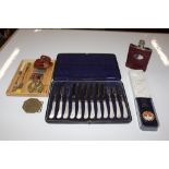 A hip flask, various buckles, two Zippo lighters,