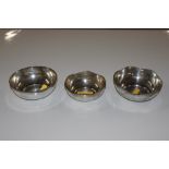 Three white metal bowls marked silver to base, tot