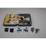 A box containing shirt studs and cuff-links