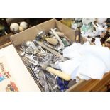 A box containing various kitchenalia and cutlery
