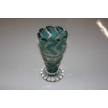A heavy cut green flash glass vase