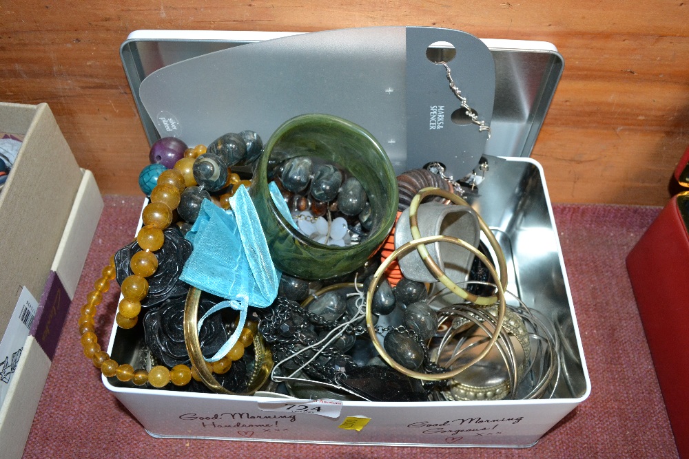 A tin of costume jewellery