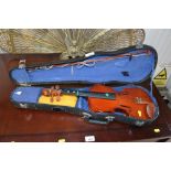 A cased students violin and bow