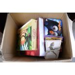 A box containing various children's books and game