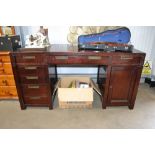 A reproduction mahogany twin pedestal desk with su