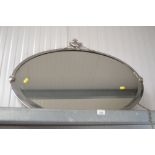 An oval framed and bevelled edge wall mirror