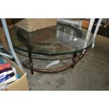 A wrought iron circular glass topped table