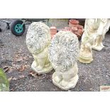 A pair of garden ornaments in the form of lions