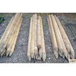 Eleven half round garden posts and two others