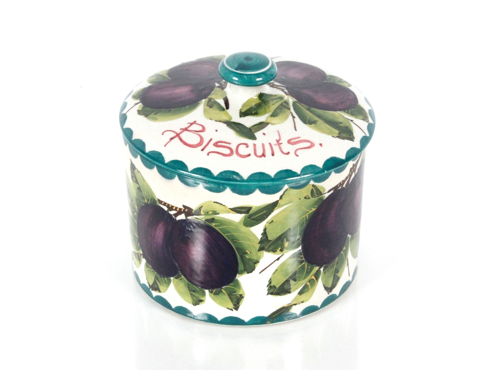 A Wemyss biscuit jar and cover decorated plums and leaves, retailed by T. Goode & Co. South Audley