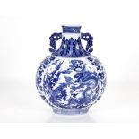 A hand painted Chinese porcelain two handled blue and white moon flask, decorated dragons, clouds