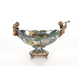 A decorative porcelain and gilt bronzed comport with cherub musician surmounts, the bowl profusely