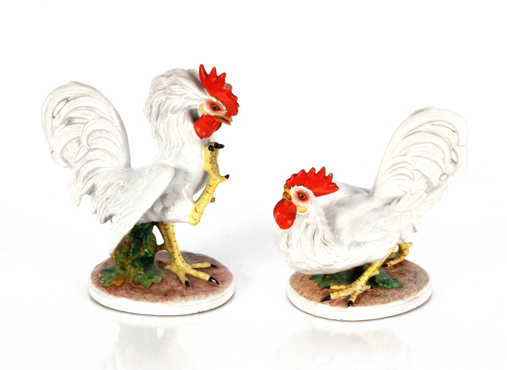 A pair of Italian porcelain figures depicting fighting cocks, 23cm x 18cm