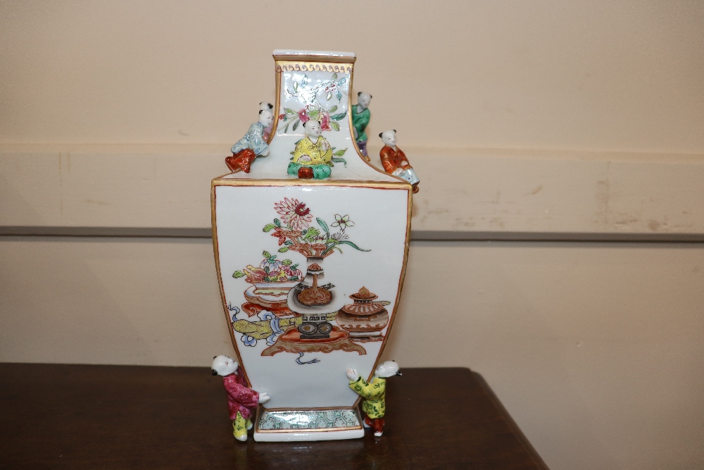 An unusual porcelain vase, painted in famille rose enamels and figures of boys applied to its - Image 7 of 15