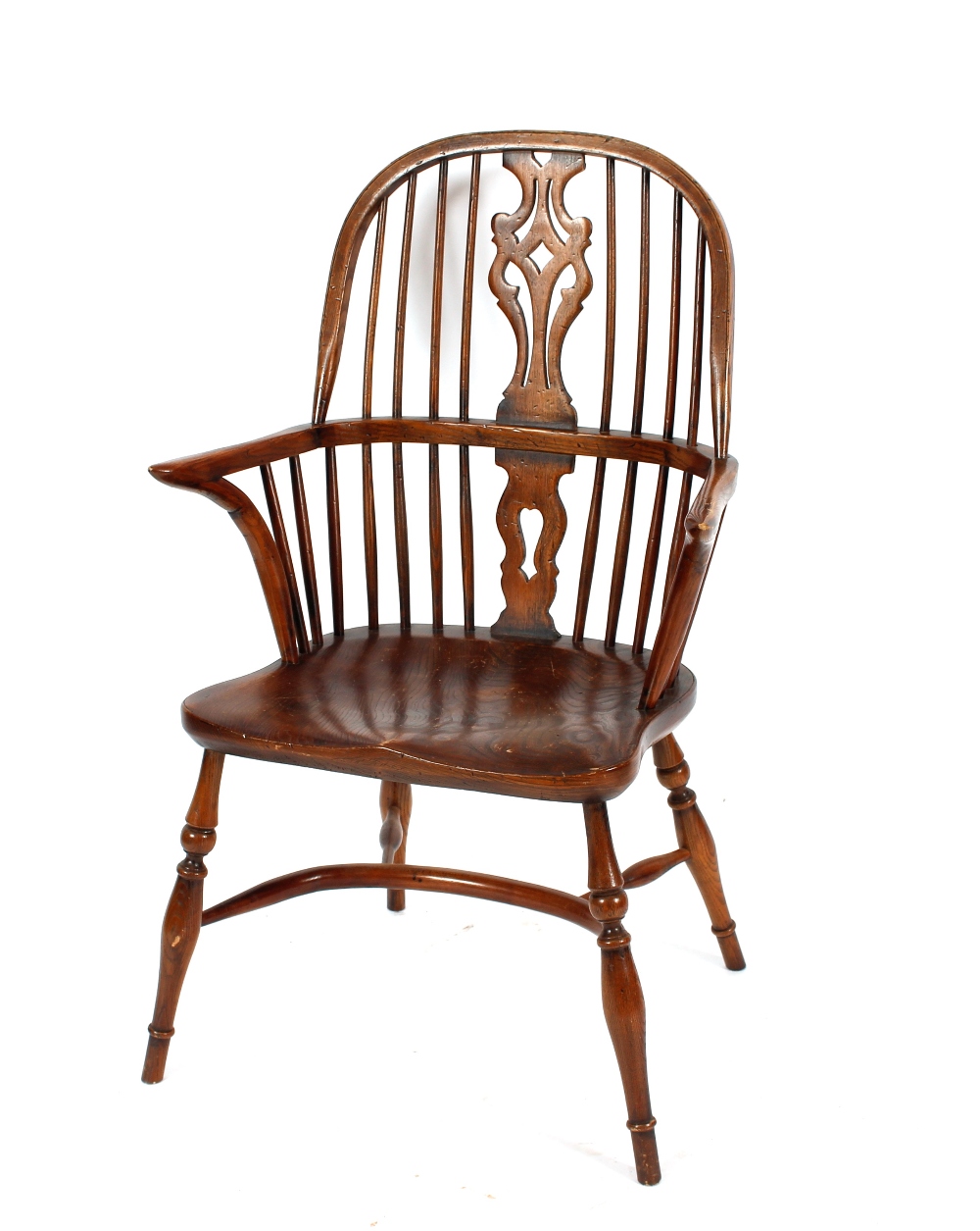 An elm stick back Windsor elbow chair, having shaped seat raised on turned tapering supports