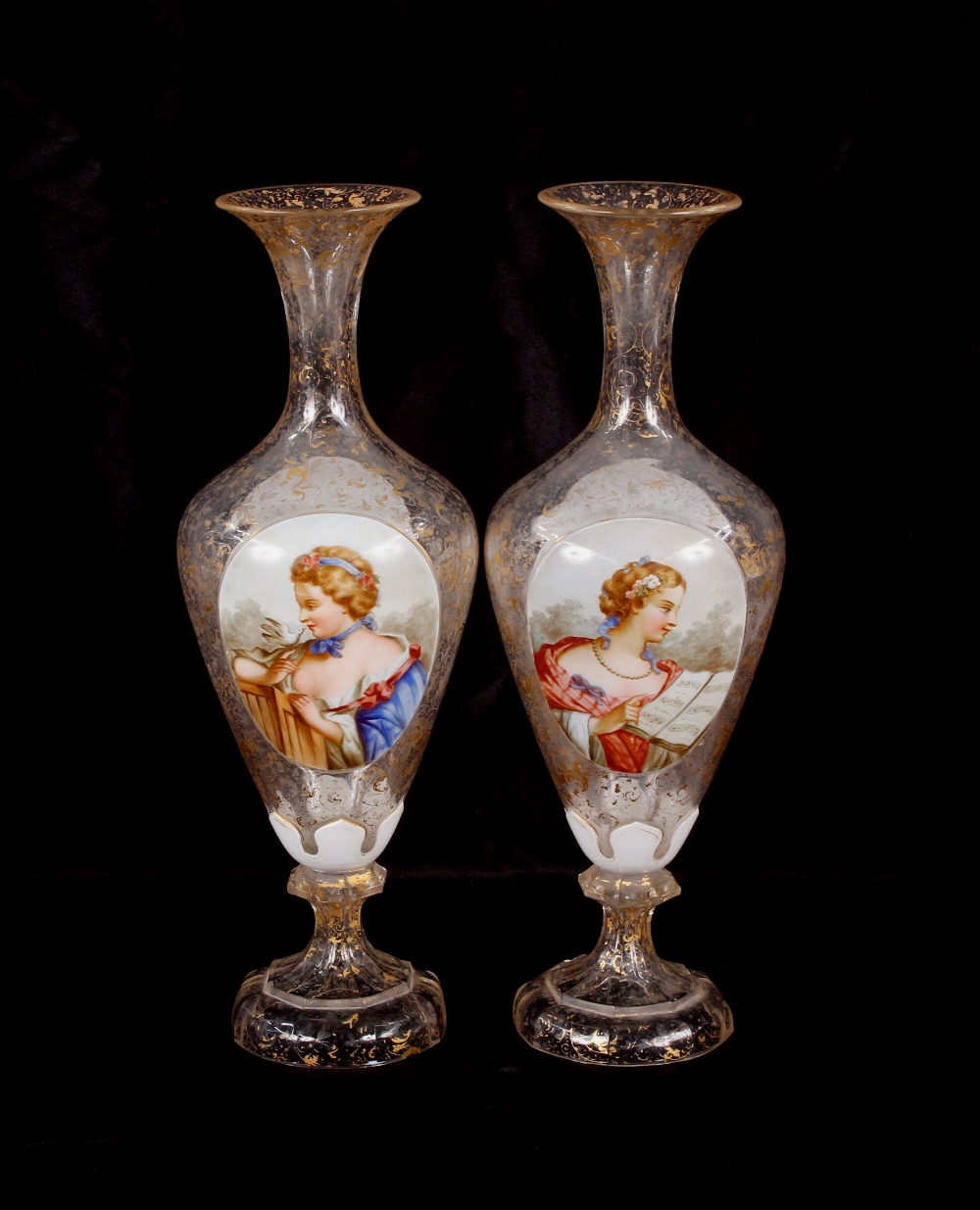 A pair of 19th Century overlaid glass baluster vases, panels decorated with maidens and flowers