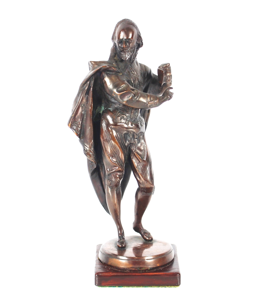 A bronze figure of Shakespeare raised on a wooden