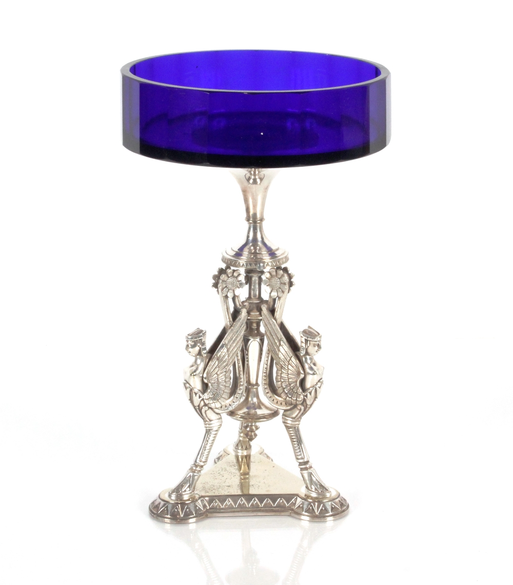 A plated comport raised on classical triform monopodia decorated base, surmounted by blue glass