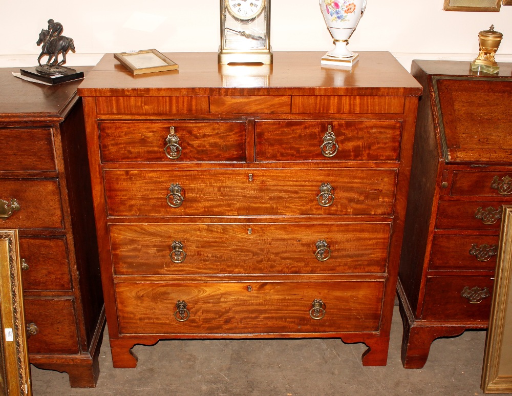 A George III mahogany chest of two short and three long drawers, raised on bracket feet, 93cm wide x