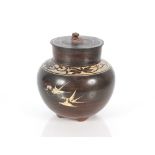 A Chinese glazed terracotta jar and cover with foliate decoration, the lid with Kylin finial, 16cm