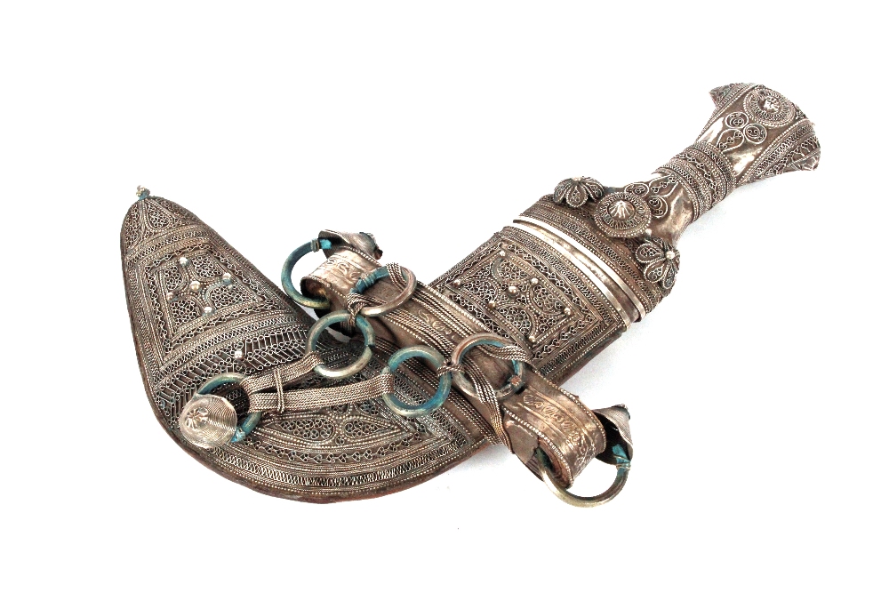 A late 19th Century Eastern white metal and filigree work decorated dagger