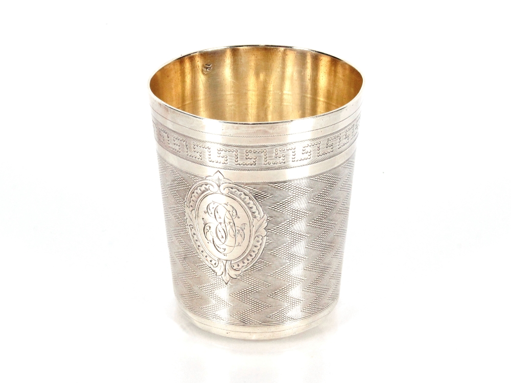 A small white metal continental beaker, having engine turned and Greek key decoration with central