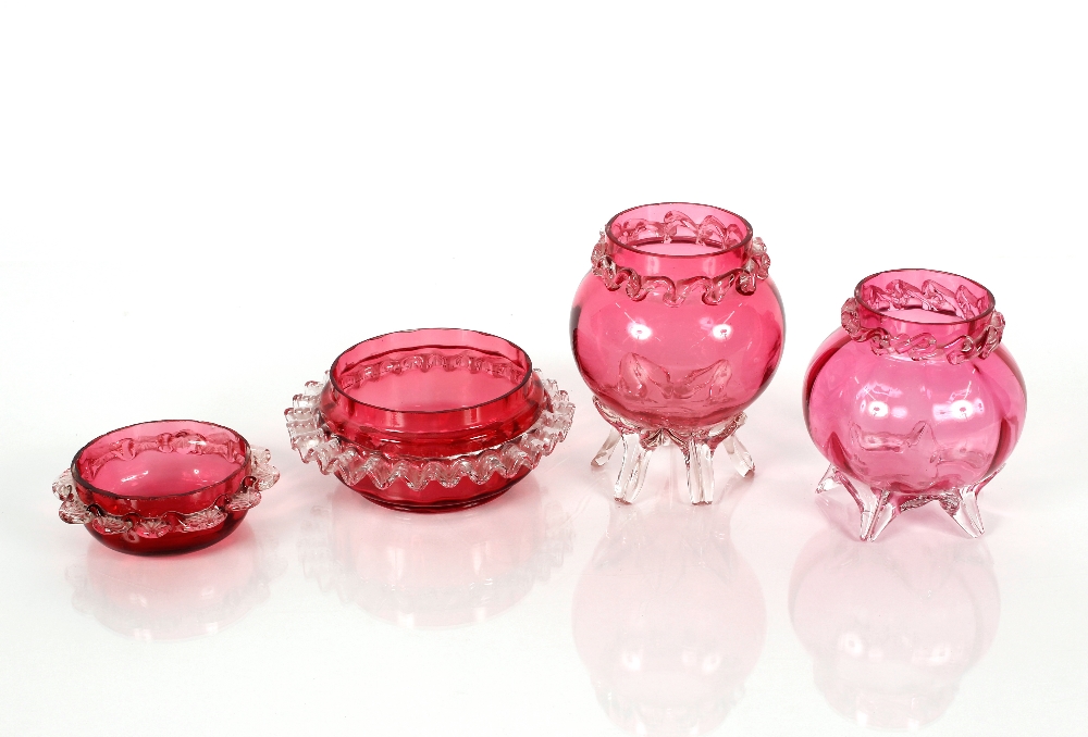 A cranberry glass posy vase, with applied clear glass rim and a smaller similar; and two other