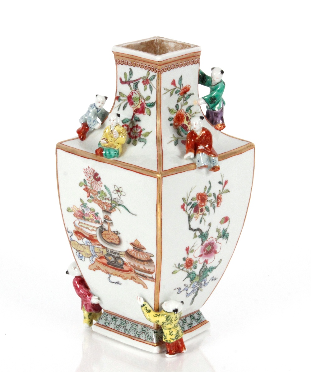 An unusual porcelain vase, painted in famille rose enamels and figures of boys applied to its