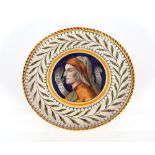 A Ginori Majolica comport, having a central panel decorated with Dante within floral border, 17cm