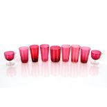 A set of six cranberry glass beakers; two cranberry punch cups; and a cranberry glass side pouring