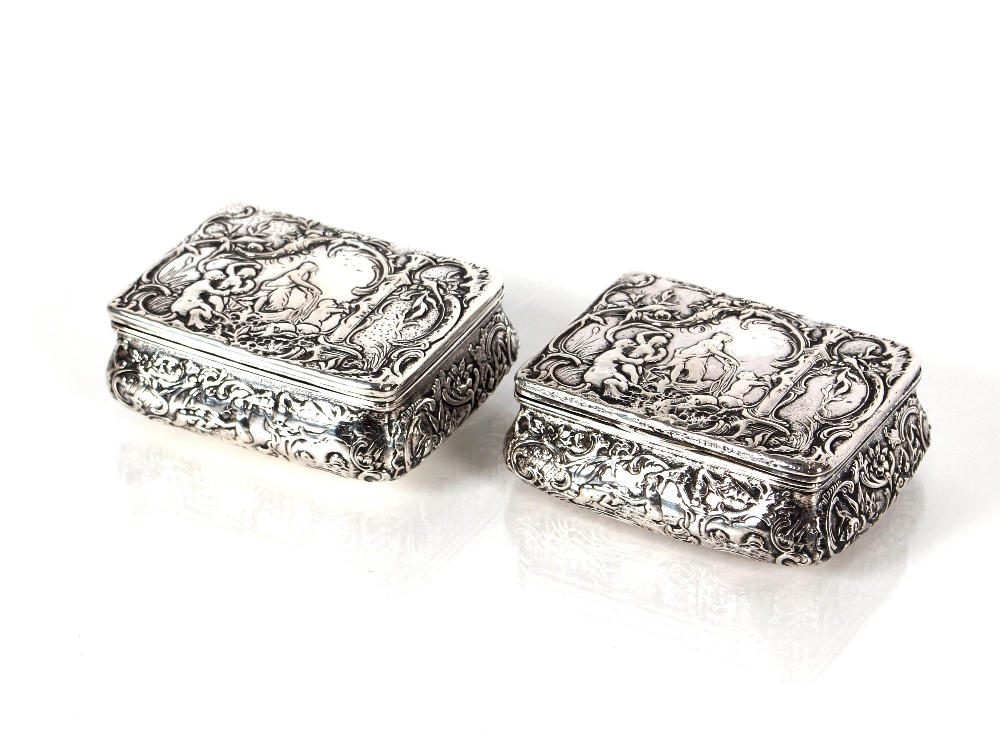 A near pair of 19th Century continental silver table snuff boxes decorated in the Rococo style,