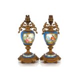 A pair of Sevres style porcelain and gilt metal mo