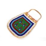 A fine American Indian Buckskin and beadwork pouch decorated with bands and stylised wigwam designs,
