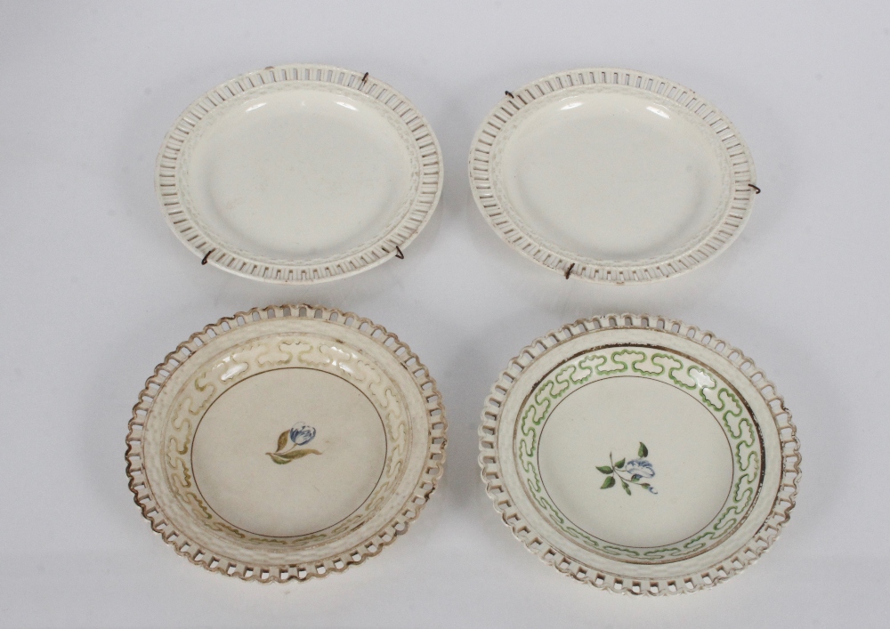 A pair of antique creamware shallow dishes with painted floral decoration and pierced borders; and a