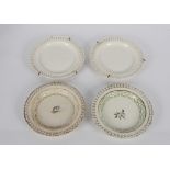 A pair of antique creamware shallow dishes with painted floral decoration and pierced borders; and a