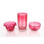 A cranberry glass celery vase with clear glass petal feet; a cranberry glass bowl with crimped