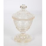 A cut glass jar and cover, surmounted by a fluted knop finial with etched foliate decoration on